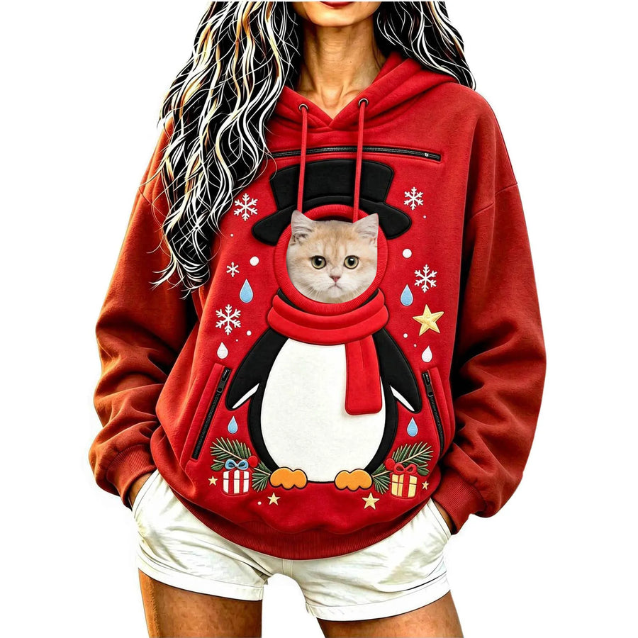 Cat peeking out of the Penguin pet pocket Christmas hoodie