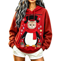 Cat peeking out of the Penguin pet pocket Christmas hoodie